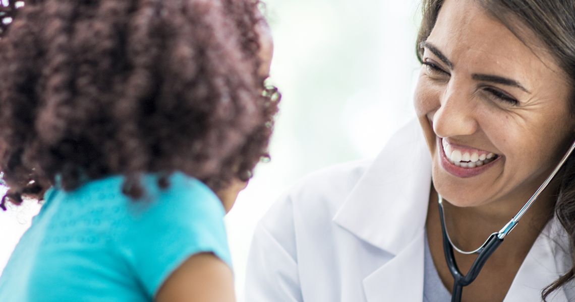 Doctor smiling at young patient